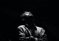 monochrome photo of man looking up