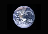 Earth from space, showing Africa and surrounding regions with white cloud cover over the blue oceans.