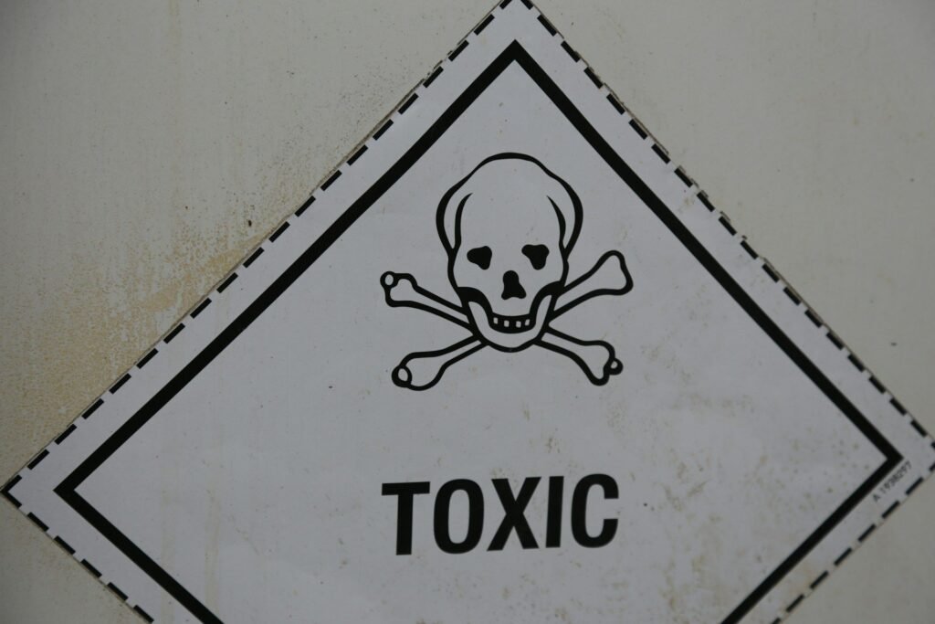 Toxic warning sign with a skull and crossbones inside a diamond-shaped border on a weathered surface