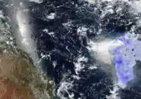 Satellite view of Earth showing Africa on the left and a purple-highlighted region off the eastern African coast in the Indian Ocean, with clouds visible overhead.