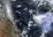 Satellite view of Earth showing Africa on the left and a purple-highlighted region off the eastern African coast in the Indian Ocean, with clouds visible overhead.