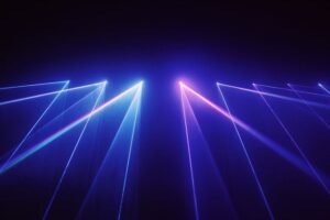 Laser light beams crisscross in blue and pink against a dark background, resembling a laser light show.