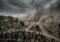 A vast graveyard under dark storm clouds with thick smoke or dust rising in the distance, rows of tombstones stretching to the horizon.