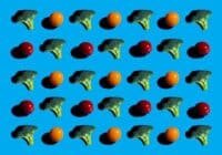 Repeating grid of broccoli florets and small orange and red tomatoes on bright blue background.