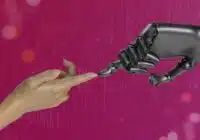 Human hand reaching toward a robotic hand against a magenta tech background, symbolizing collaboration.