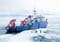 Arctic research vessel with red cranes on a cracked ice field and a small group of people inspecting the area
