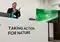Speaker at a conference podium with a banner reading 'Taking Action for Nature' and a presentation screen beside him.